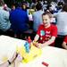 Plymouth resident Eric Foor, 11, plays Rock'Em Sock'Em  Robots with Amy Geltz  at the German Picnic on Saturday, June 29. This is his fifth time attending the picnic. Daniel Brenner I AnnArbor.com